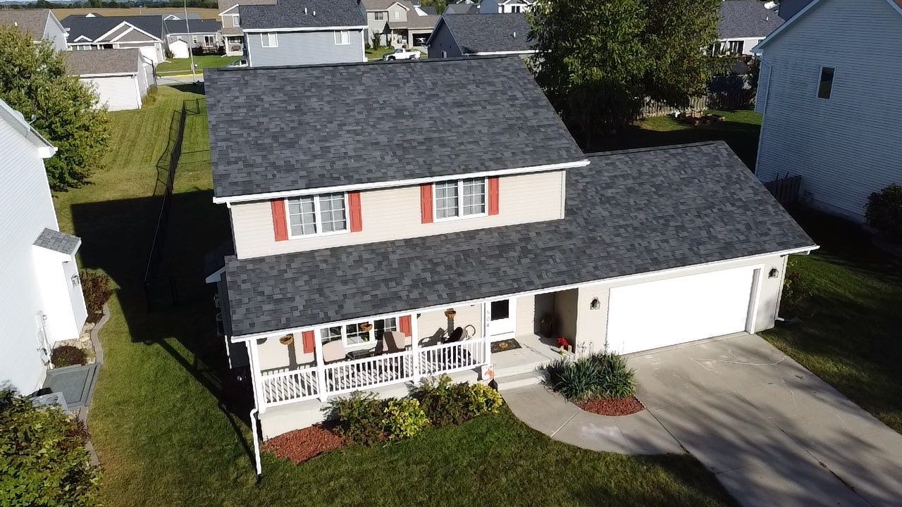 dark roof with red shutters on windows